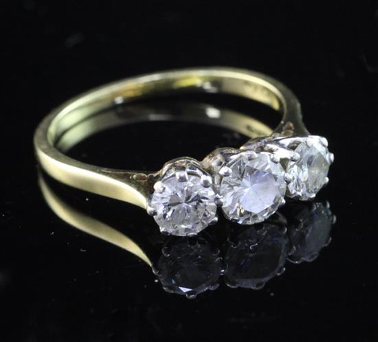 An 18ct gold and three stone diamond ring, size N.